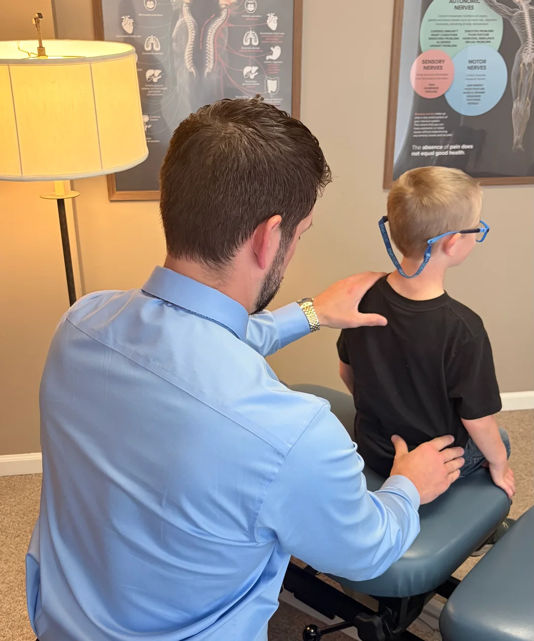 Dr. Sam Hendricks providing pediatric chiropractic care